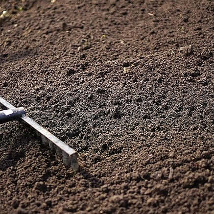 multi purpose top soil being raked